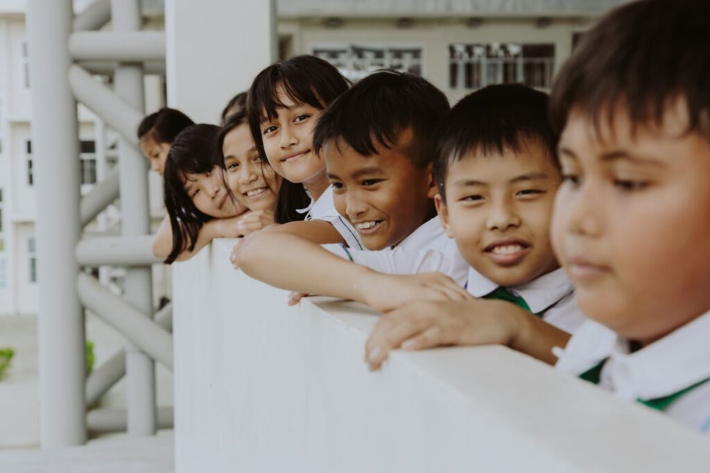 pexels-photo-10646608 A group of smiling children in school uniforms enjoying togetherness outdoors.